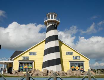 One of the top Port Aransas gift shops can be seen, shopfront shaped like a lighthouse. 